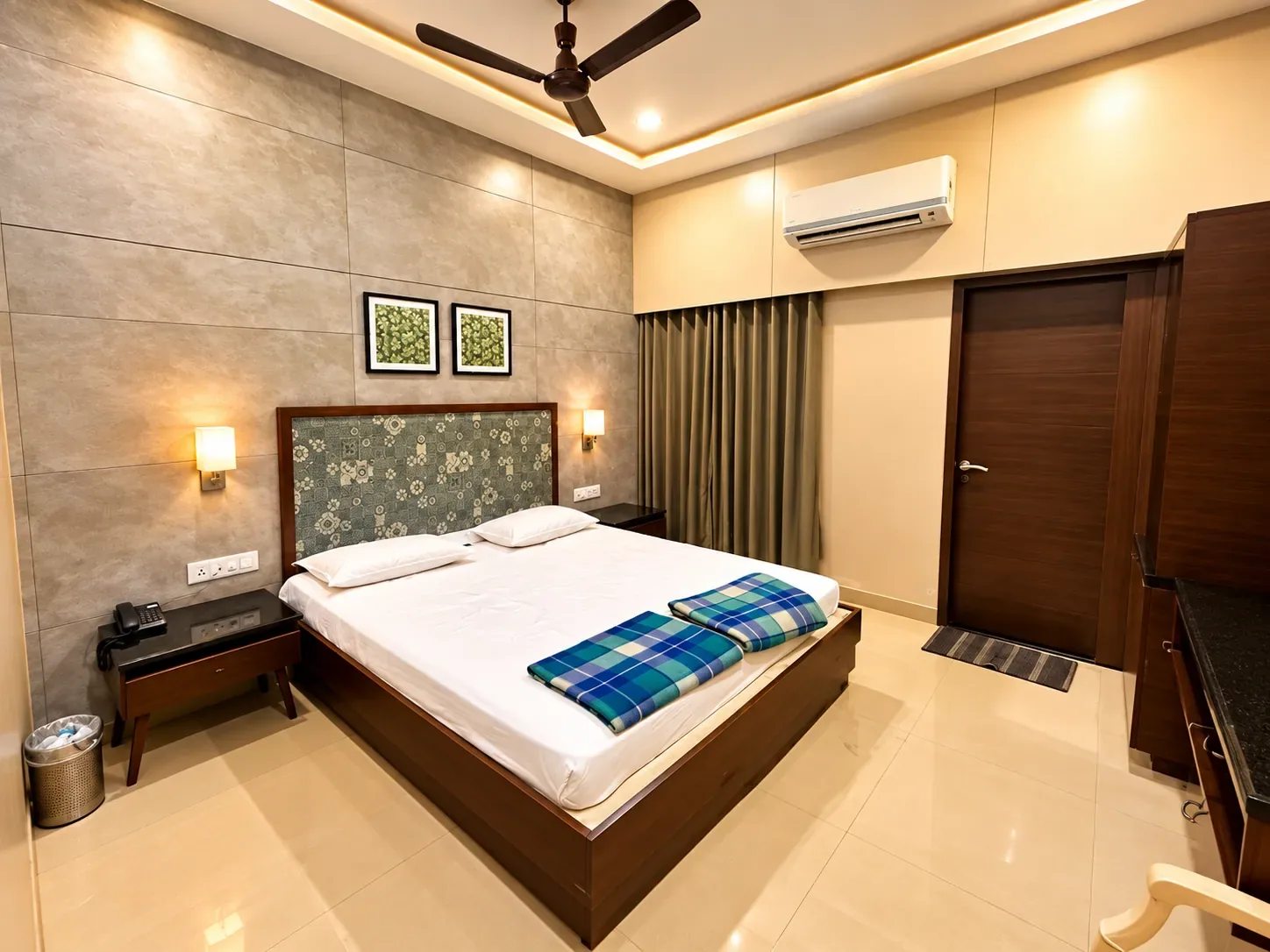 AC double room with floral headboard and split air conditioner at the Dharamshala in Bhuj